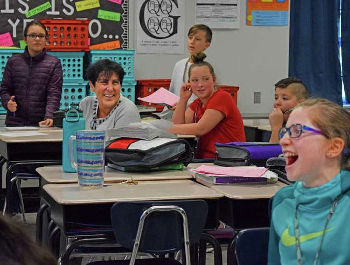 Liberty Middle School Principal Beth Crumbacher smiles as she watches students participate in an educational game on Wednesday during their seventh-period math class.