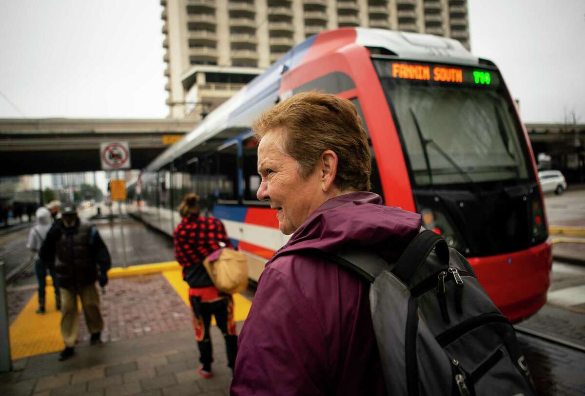Shari Wilson gets off of the Metro light rail at the downtown transit station on her way to get groceries. After years living off and on in a tent, Wilson recently received temporary housing through Catholic Charities.