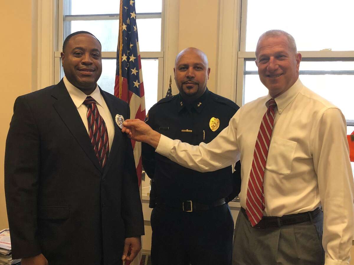 Shelton Police Officer John Staples Jr., left, with Mayor Mark Lauretti, right, and Police Chief Shawn Sequeira at his swearing in last January, is heading up the department's new crime prevention and neighborhood watch program.