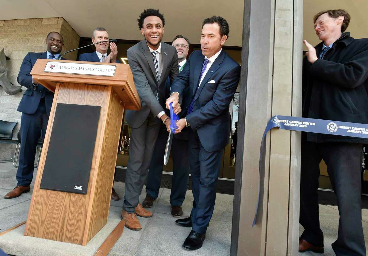 Jason Howell, Albertus Magnus Student Government Association president, center left, and Albertus Magnus College President Marc M. Camille,center right, cut the ceremonial ribbon Wednesday opening the $12.5 million renovated Hubert Campus Center at the New Haven school. Also shown are, from left, Andrew Foster, vice president of student services; Vincent P. Petrini, Yale New Haven Health senior vice president of public affairs and chairman of the Albertus Magnus College board of trustees; Hamden Mayor Curt B. Leng; and New Haven Mayor Justin Elicker.