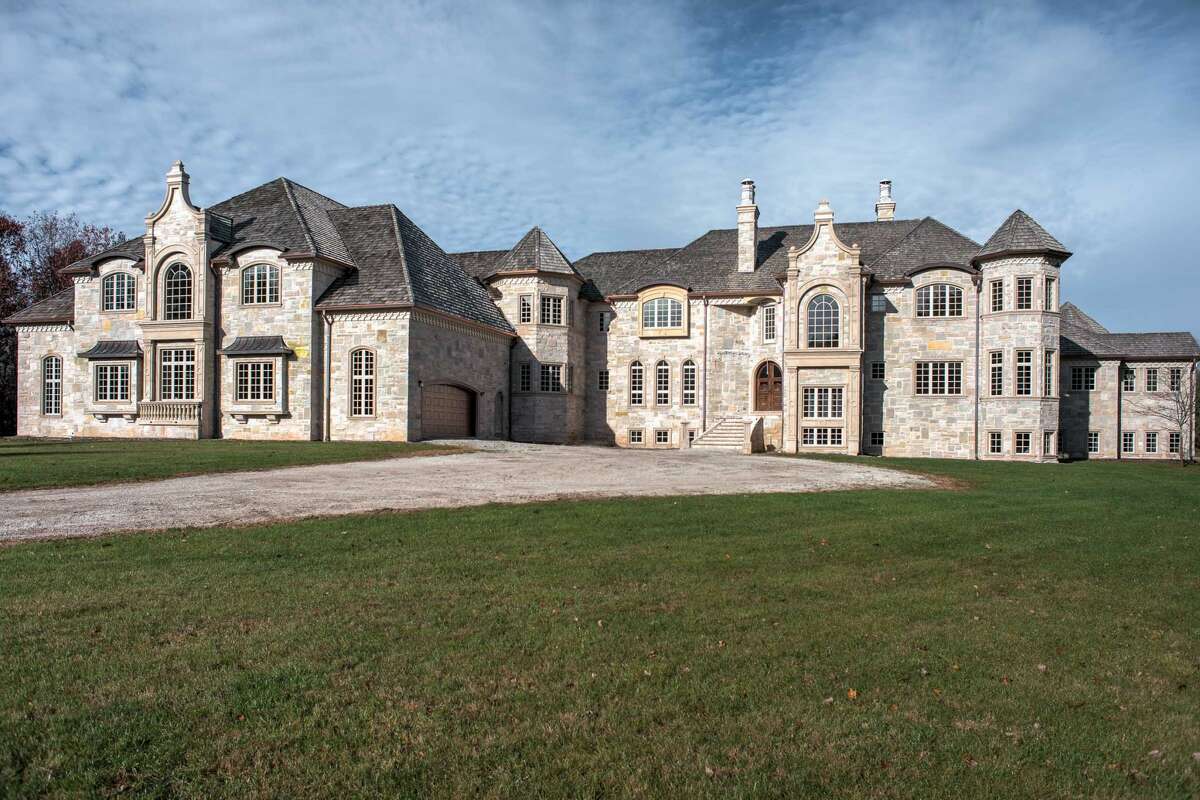 This stone, French-style chateau with three levels, eight bedrooms, seven full baths and three half baths, with 27,699 square feet on approximately 2.73 acres of land in Oneida, WI is up for auction next month. It's also the house next to football star Aaron Rogers.