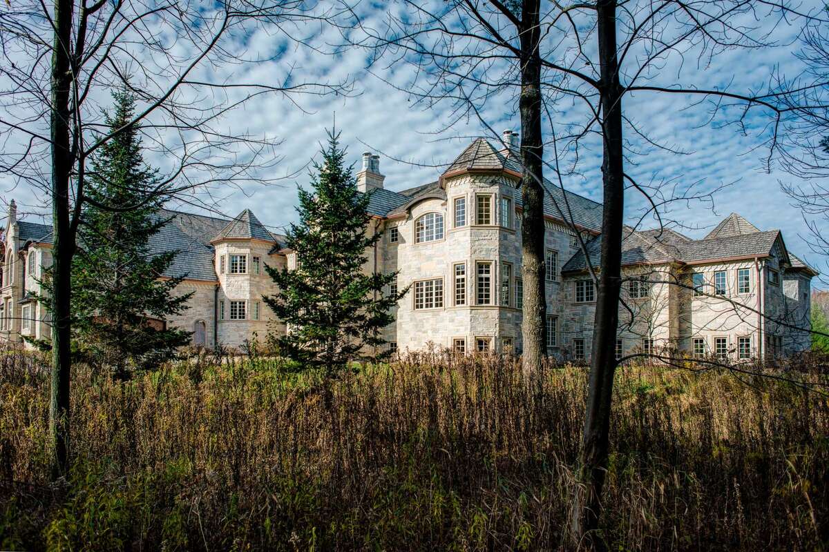This stone, French-style chateau with three levels, eight bedrooms, seven full baths and three half baths, with 27,699 square feet on approximately 2.73 acres of land in Oneida, WI is up for auction next month. It's also the house next to football star Aaron Rogers.