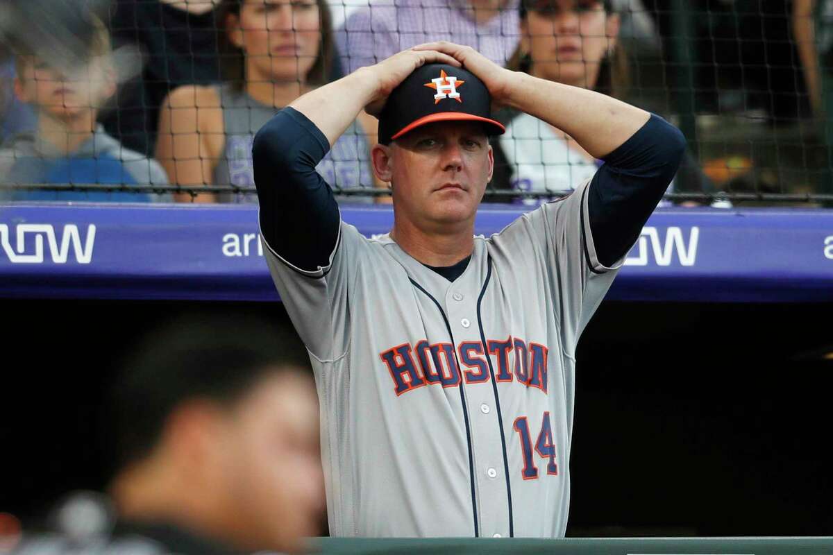 Astros manager AJ Hinch and general manager Jeff Luhnow were fired for the team’s sign-stealing during its run to the 2017 World Series title. In this July 2, 2019, file photo, Houston Astros manager AJ Hinch reacts during a baseball game against the Colorado Rockies, in Denver.