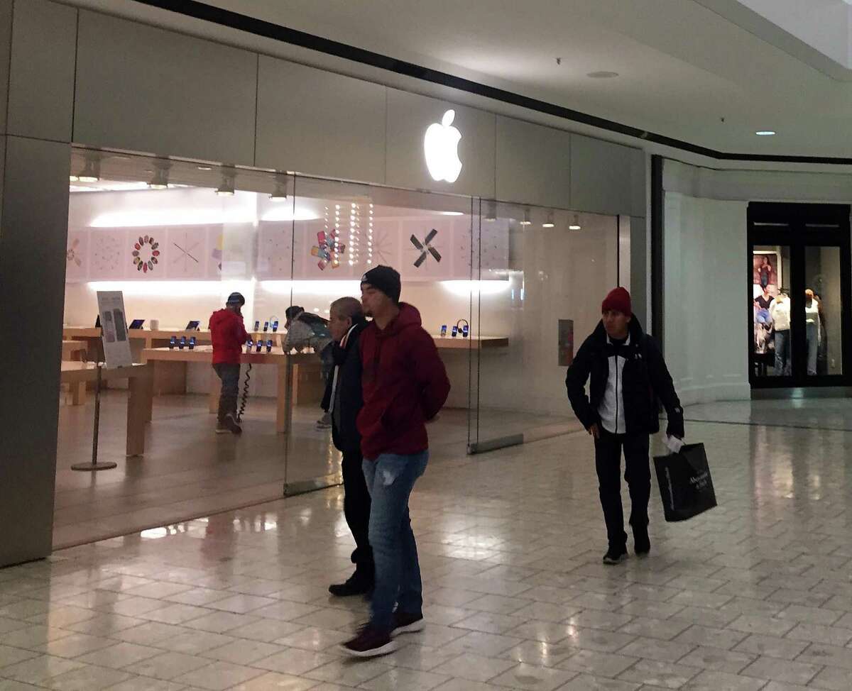 Shoppers walk past the Apple store in the Stamford Town Center mall on Monday, Jan. 13, 2020. Apple has announced that it is closing the store, which will replaced by a new store at the SoNo Collection mall in Norwalk.