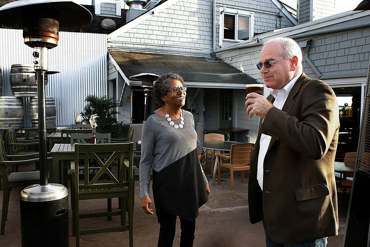 Lenny Mendonca (right) with Mary Oldham (left) show where town hall forums take place at his family business, Half Moon Bay Brewing Company in Half Moon Bay, Calif., on Thursday, December 18, 2014. He has been nominated for our Chronicle "Visionary" Award for his work as one of the state's most selfless activists on good government and government reform.