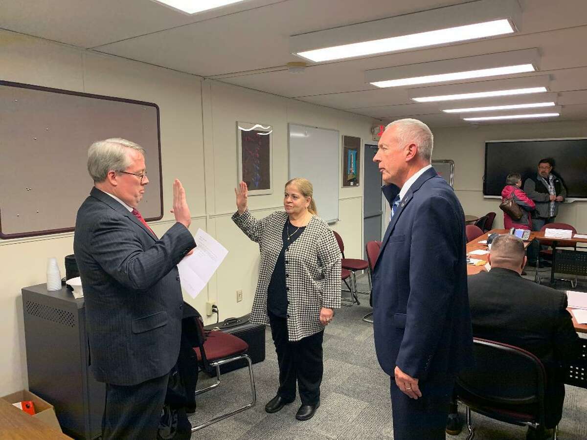 Joseph McQuade, a lawyer for Ansonia’s Board of Education, administers the oath to Phil Tripp and Fran DiGiorgi as school board members in November. The Board’s selection of Tripp set off a firestorm which has resulted in the city seeking a state court judge to determine whether the Board of Aldermen or the Board of Education has the authority to fill a school board vacancy.
