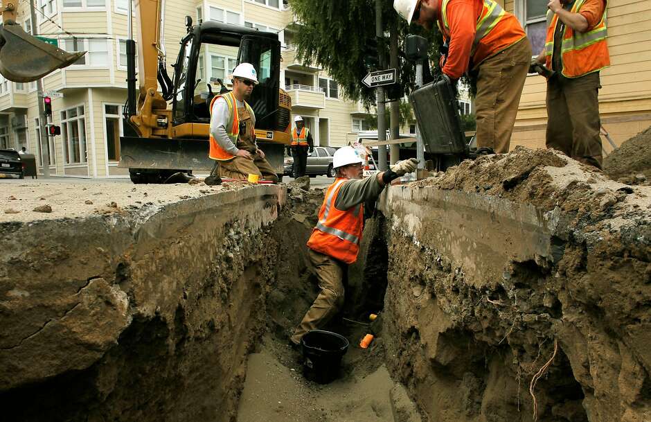 PG&amp;E workers repair a gas line in San Francisco in 2011. A state regulator has proposed increasing the penalty the utility would pay for record-keeping problems discovered in its gas division.
