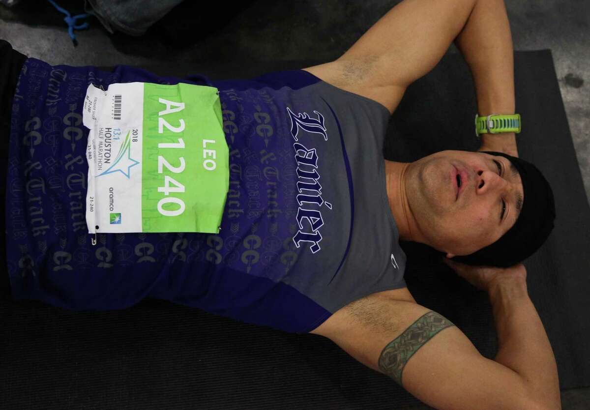 Do adopt a Zen mindset. Leo Hernandez, of Houston, stretches to warm up at the George R. Brown Convention Center.