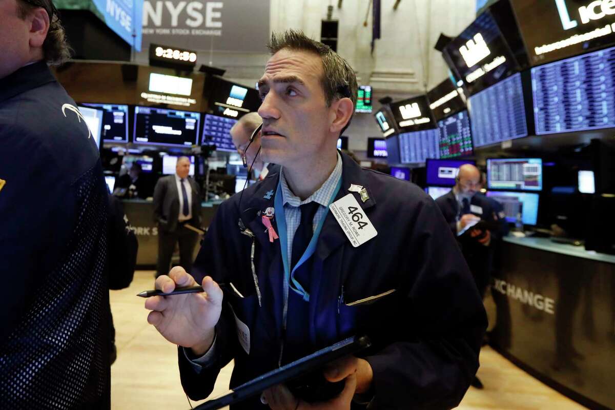 FILE - In this Jan. 10, 2020, file photo trader Gregory Rowe works on the floor of the New York Stock Exchange. (AP Photo/Richard Drew, File)