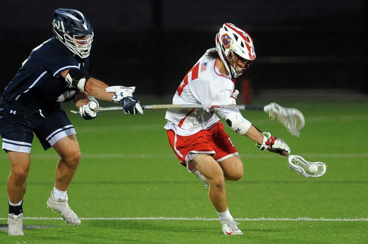 Fairfield Prep's Max McGillicuddy (6) scoops up the ball as Wilton's Ryan Schriber (12) tries to disrupt him during Class L boys lacrosse semi-final action in Fairfield, Conn., on Wednesday June 5, 2019.