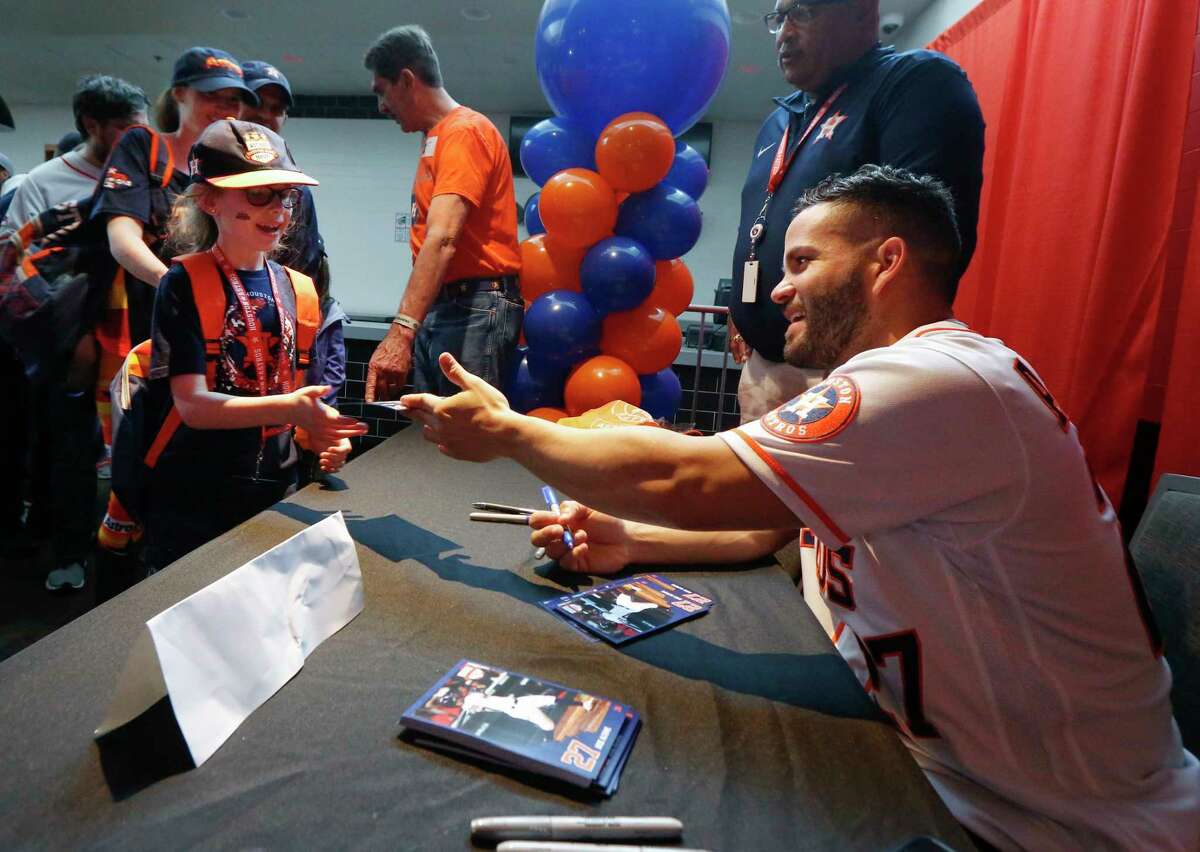 Jose Altuve signed autographs for young fans during FanFest at Minute Maid Park Saturday, Jan. 18, 2020, in Houston.