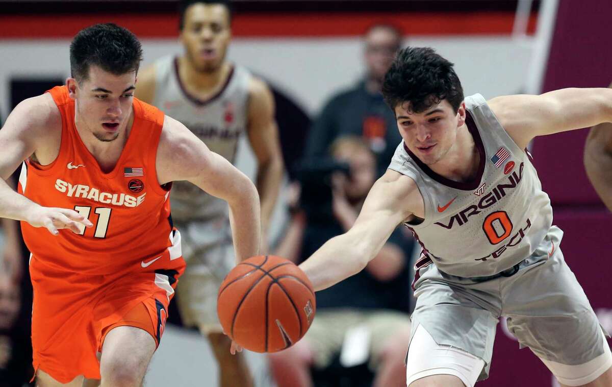 Syracuse's Joseph Girard III (11) and Virginia Tech Hunter Cattoor (0) battle for a loose ball during the second half of an NCAA college basketball game in Blacksburg Va., Saturday, Jan. 18 2020. (Matt Gentry/The Roanoke Times via AP)