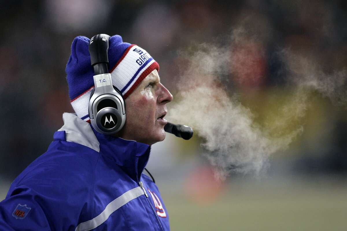 FILE - In this Jan. 20, 2008, file photo, New York Giants NFL football head coach Tom Coughlin watches during the first half of the NFC Championship football game against the Green Bay Packers, in Green Bay, Wis. The coldest NFC championship game was the Giants' 23-20 overtime victory at the Packers during the 2007 season. Coughlin's crew had knocked off the top-seeded Cowboys in the divisional round, and his bright red cheeks in the minus-1 temperature with minus-23 wind chill at Lambeau Field provided the image many remember from that game. (AP Photo/David Duprey, File)