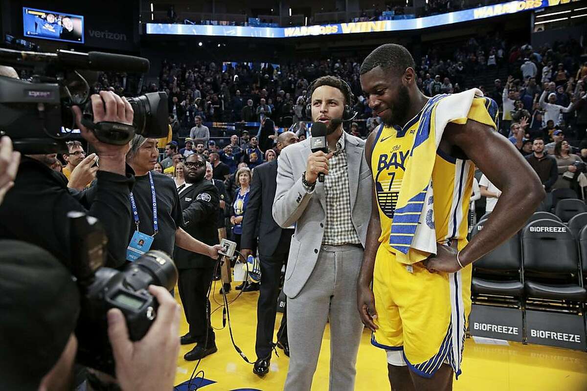 From left: Golden State Warriors guard Stephen Curry taking a role as an NBC sports analyst interviews Warriors forward Eric Paschall (7) following the NBA game at Chase Center, Saturday, Jan. 18, 2020, in San Francisco, Calif. The Warriors won 109-95 against the Orlando Magic.
