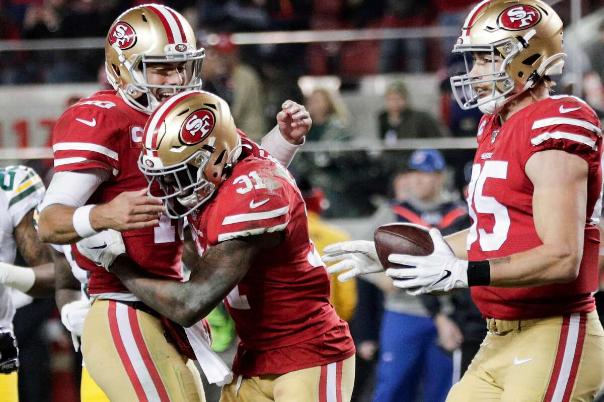 San Francisco 49ers’ Jimmy Garoppolo and Raheem Mostert react to Mostert’s touchdown in the third quarter during the NFC Championship game between the San Francisco 49ers and the Green Bay Packers at Levi’s Stadium on Sunday, Jan. 19, 2020 in Santa Clara, Calif.