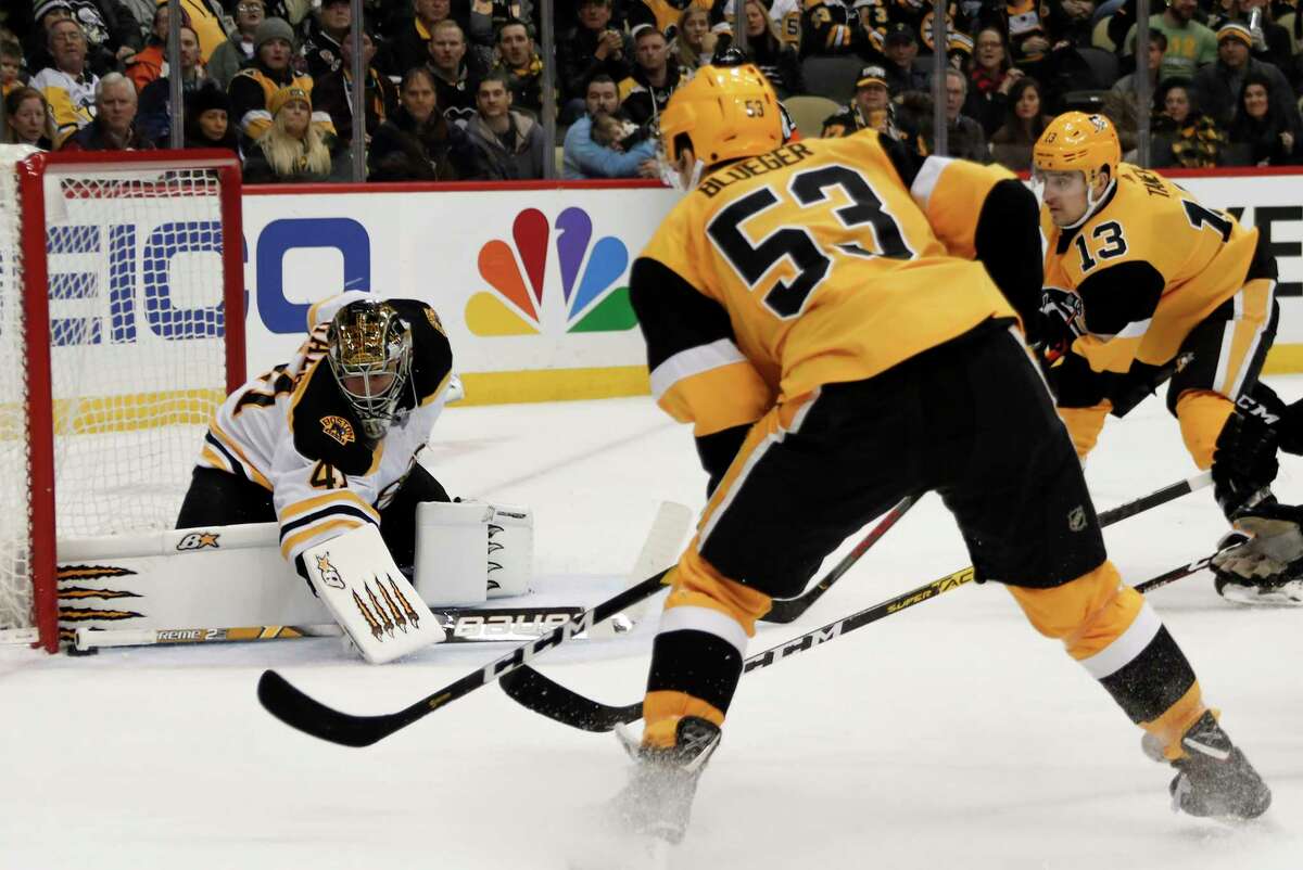Boston Bruins goaltender Jaroslav Halak (41) keeps the puck out of the net as Pittsburgh Penguins' Teddy Blueger (53) and Brandon Tanev (13) look for a rebound during the second period of an NHL hockey game, Sunday, Jan. 19, 2020, in Pittsburgh. (AP Photo/Keith Srakocic)