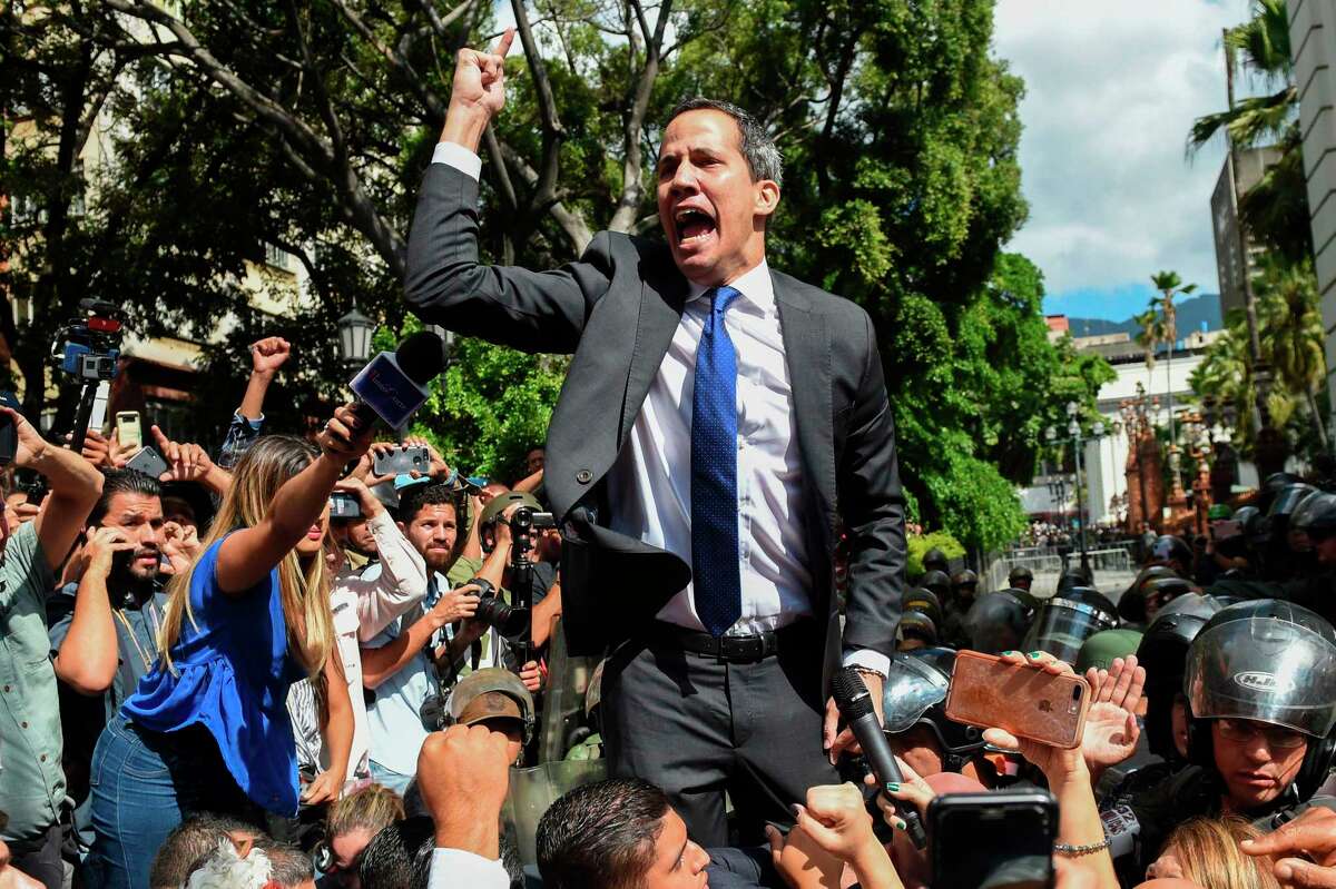 Venezuelan opposition leader and self-proclaimed acting president Juan Guaido shouts on his way to the National Assembly, in Caracas, on January 7, 2020. - Opposition leader Juan Guaido and a rival lawmaker, Luis Parra -who both had claimed to be Venezuela's parliament speaker, following two separate votes and accusations of a "parliamentary coup- called for a parliamentary session today. (Photo by Cristian Hernandez / AFP) (Photo by CRISTIAN HERNANDEZ/AFP via Getty Images)