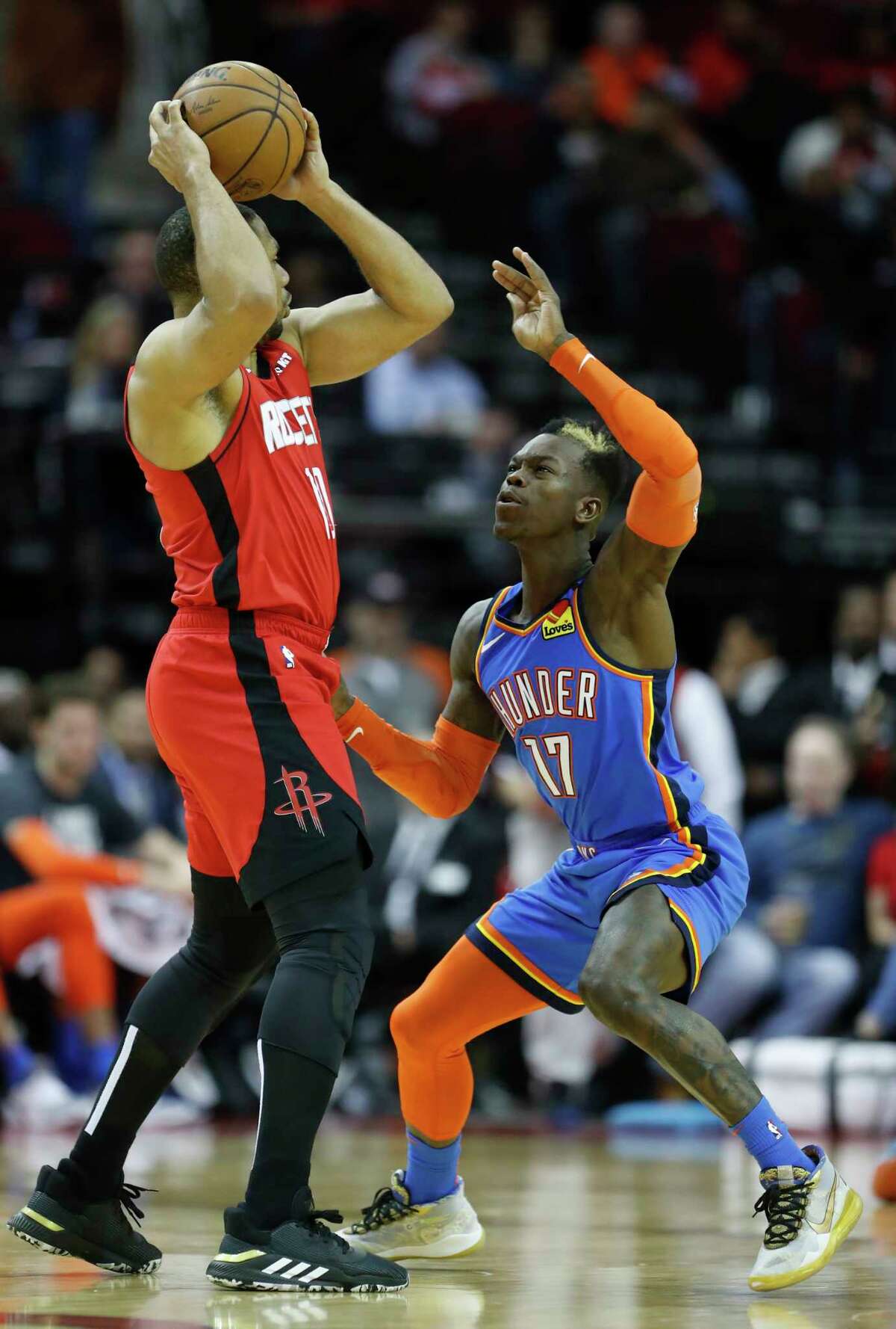 Houston Rockets guard Eric Gordon (10) looks to pass over Oklahoma City Thunder guard Dennis Schroder (17) during the second half of an NBA basketball game at Toyota Center, in Houston, Monday, Jan. 20, 2020.