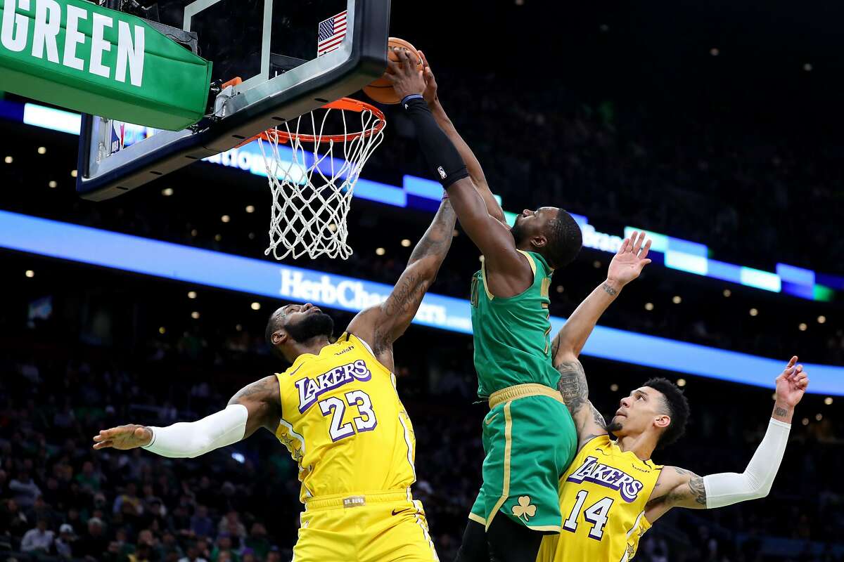 BOSTON, MASSACHUSETTS - JANUARY 20: Jaylen Brown #7 of the Boston Celtics dunks over LeBron James #23 and Danny Green #14 of the Los Angeles Lakers at TD Garden on January 20, 2020 in Boston, Massachusetts. The Celtics defeat the Lakers 139-107. (Photo by Maddie Meyer/Getty Images)