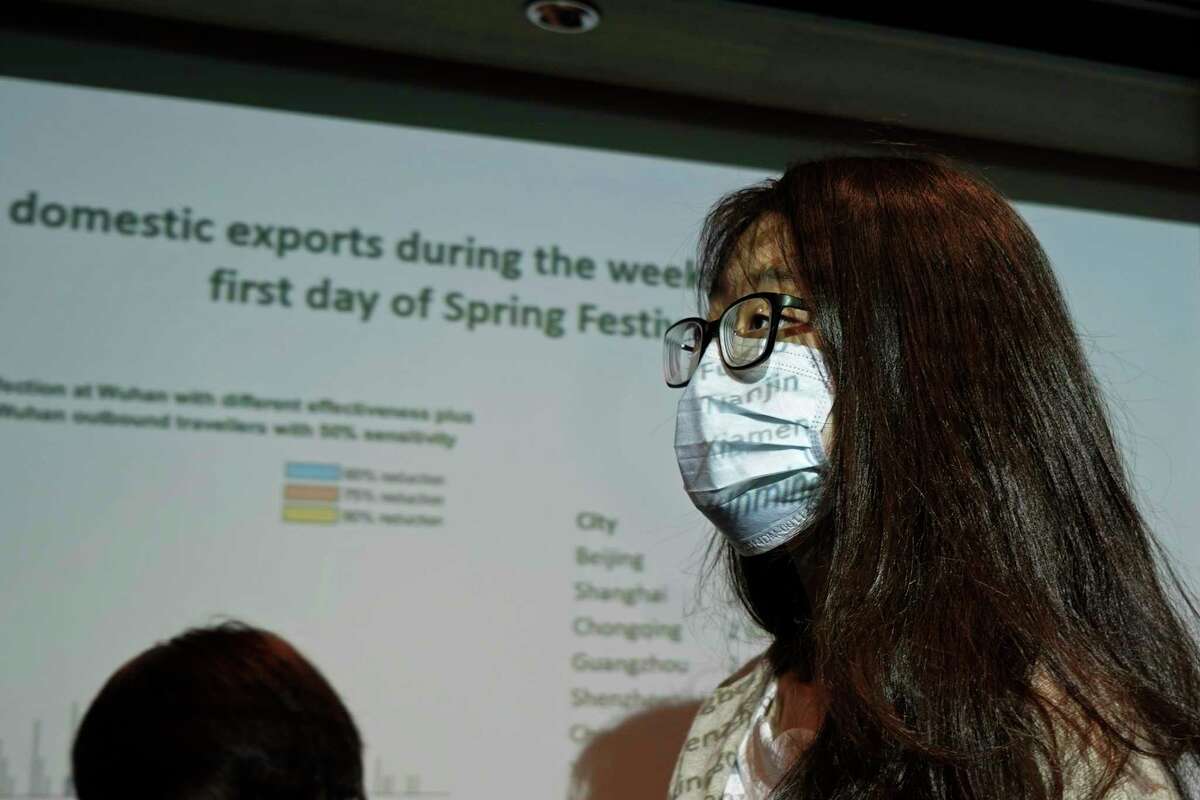 A reporter wearing mask, attends a news conference on the Wuhan coronavirus outbreak, in Hong Kong, Tuesday, Jan. 21, 2020. A fourth person has died in an outbreak of a new coronavirus in China, authorities said Tuesday, as more places stepped up medical screening of travelers from the country as it enters its busiest travel period.