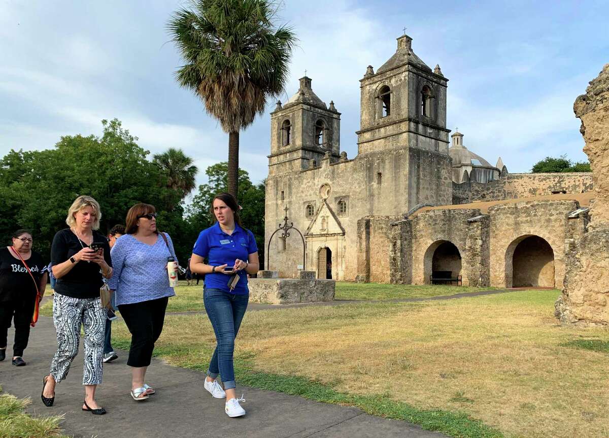 People leave after experiencing the annual double solar illumination seen at Mission Concepcion, 807 Misson Road, at precisely 6:30 p.m. on Thursday, Aug. 15, 2019. This once-a-year event has sunlight shining through the window above the front door to the center of the cross-shaped church. At exactly the same moment, sunlight coming through a dome window shines onto the face of the Virgin Mary painting above the main altar. Several historic Spanish missions have solar illuminations but a double one is rare, officials say.