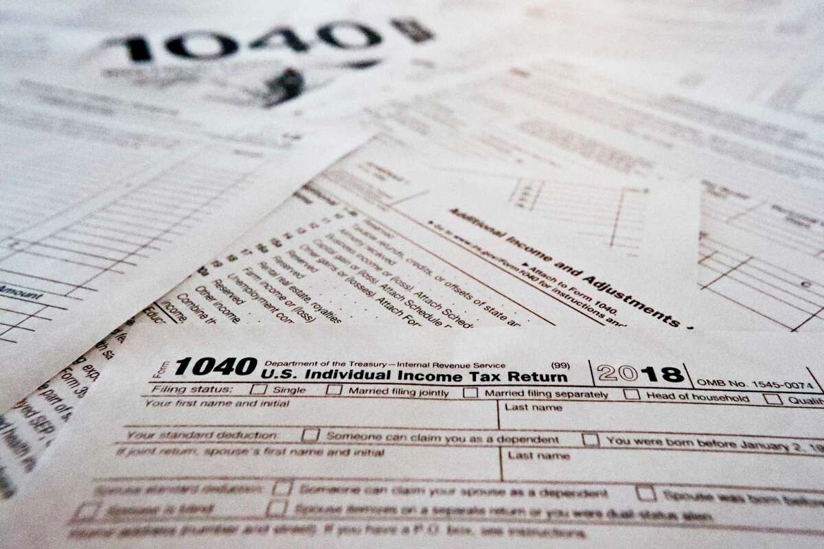 FILE - This Feb. 13, 2019 file photo shows multiple forms printed from the Internal Revenue Service web page. (AP Photo/Keith Srakocic)