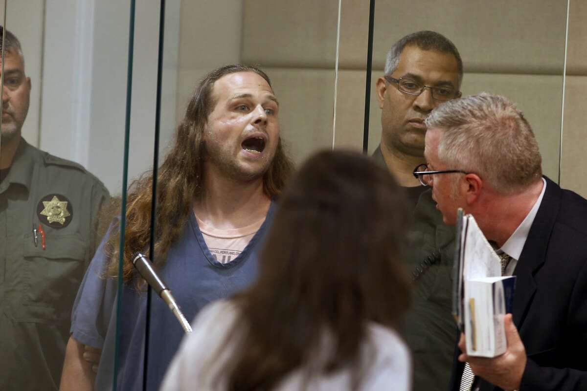 In this May 30, 2017, fie photo, Jeremy Christian shouts as he is arraigned in Multnomah County Circuit Court in Portland, Ore. Christian, charged with fatally stabbing two men who authorities say confronted him during a racist rant on a Portland, Oregon light-rail train, goes to trial Tuesday, Jan. 21, 2020, two years after the killings that plunged this liberal city into months of soul-searching.