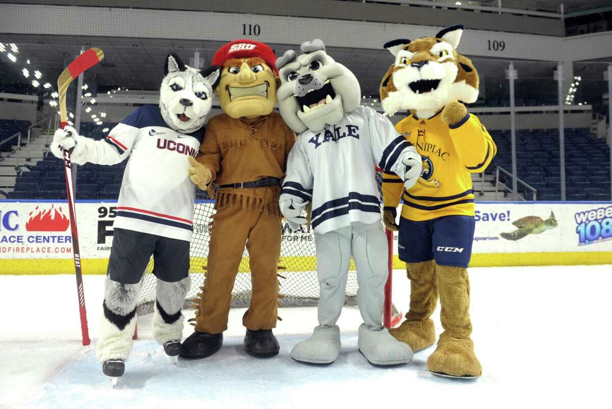 UConn’s Johnathan the Husky, Sacred Heart’s Big Red the Pioneer, Yale’s Boola the Bulldog and Quinnipiac’s Boomer the Bobcat, the four mascots from Connecticut universities participating in the Connecticut Ice gather on the ice at Webster Bank Arena in Bridgeport on Dec. 16, 2019.