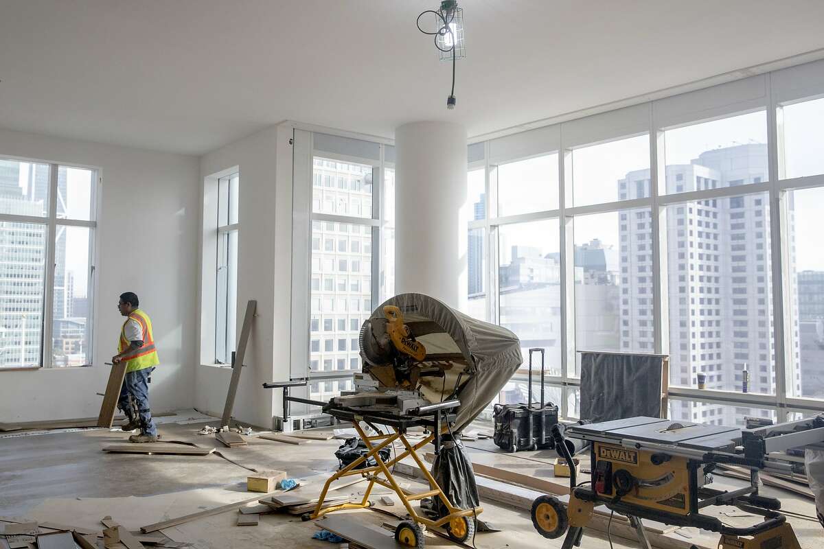 Crews work to install hardwood floors inside an apartment under construction at the Four Seasons Private Residence 706 Mission in San Francisco, Calif. Friday, December 20, 2019.