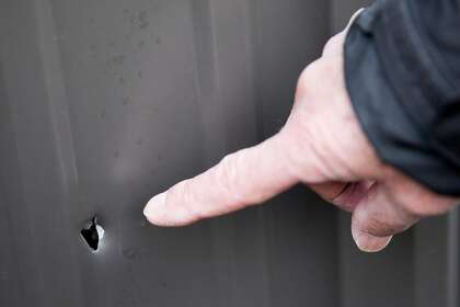 Napa vintner Igor Sill points to a bullet hole in a metal barn at Sill Family Vineyards.