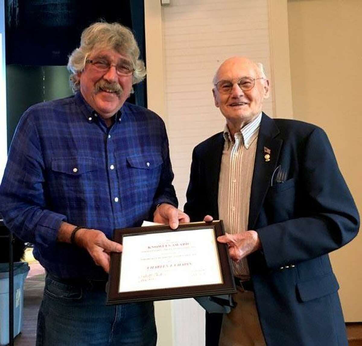 Eric Lundgren, Northville Residents Association board member, left, presents the Agnes & Samuel Knowles Award for Outstanding Community Service to Chapin.