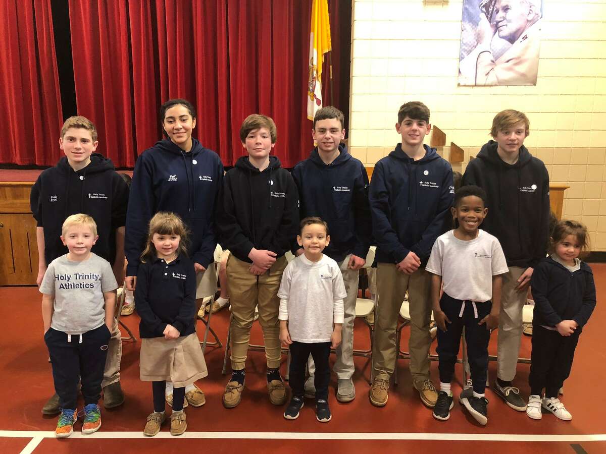 Holy Trinity Catholic Academy held its eighth grade pin ceremony Thursday, Jan. 16. Pictured are (back, left to right) Alex Balko, Tatiana Bell, Jacob Bisset, Matthew Conelius, Nicolas Coppola and Brady Grinvalsky with their kindergarten buddies (front, left to right) Jordan, Molly, Mason, Matai and Abby.
