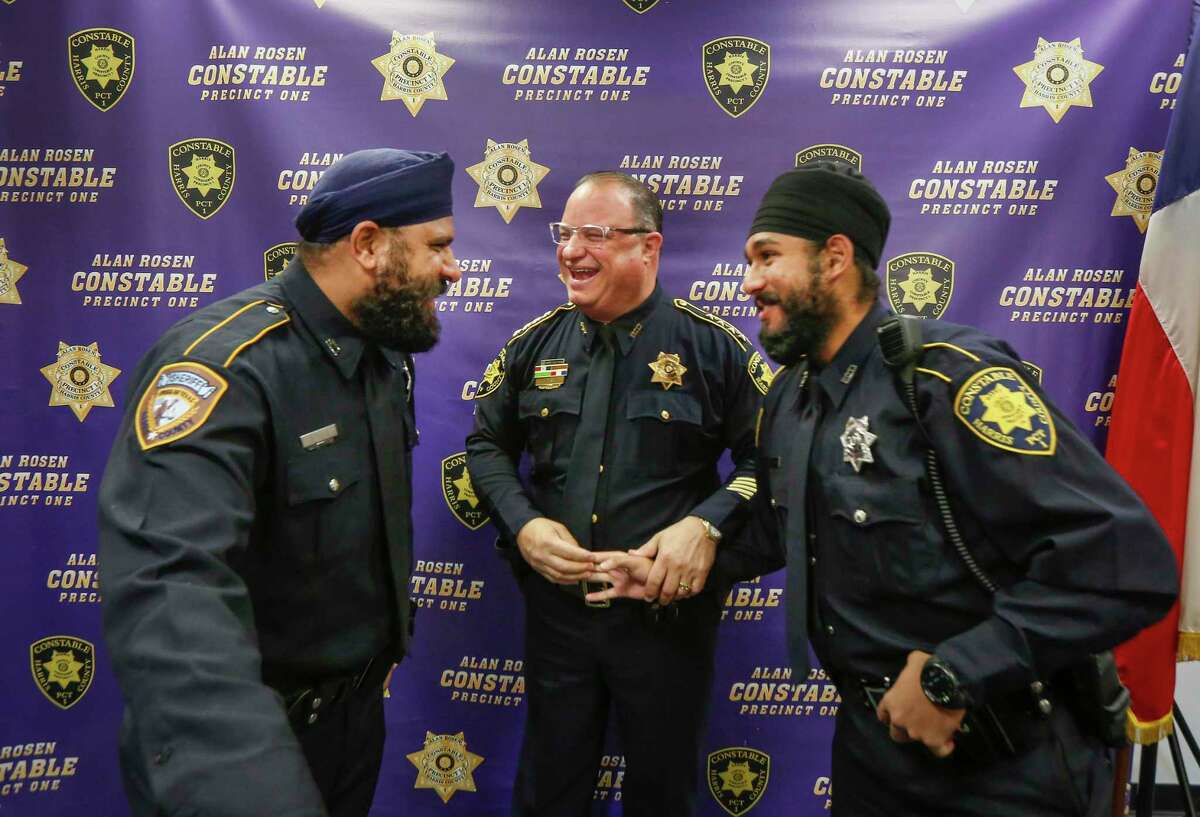Harris County Sheriff Deputy Navdeep Nijjar, Constable Alan Rosen and Deputy Amrit Singh share a light moment after Singh was sworn-in Tuesday, Jan. 21, 2020, in Houston. Singh is the first Sikh Deputy Constable in Harris County history. His swearing-in coincides with the adoption by nearly all Harris County Constables of a religious "Articles of Faith" policy which allows all those who serve to wear articles of faith while discharging their duties in uniform.