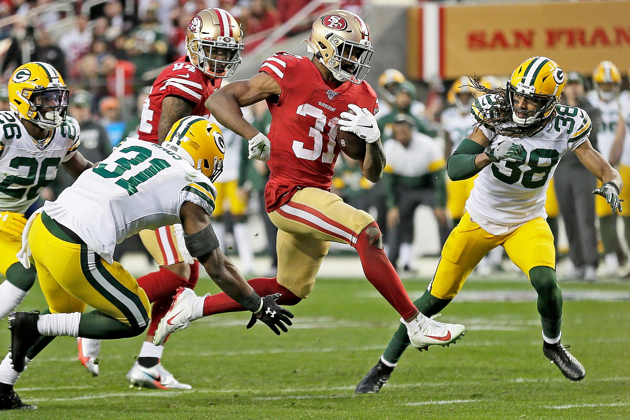 San Francisco 49ers running back Tevin Coleman (26) runs for four yards  against the Green Bay Packers in the second quarter of the NFC Championship  at Levi's Stadium in Santa Clara, California