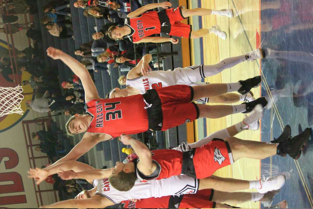 Canyon Reed (34) tries to make the play on Friday against Big Rapids (Herald Review photo/John Raffel)