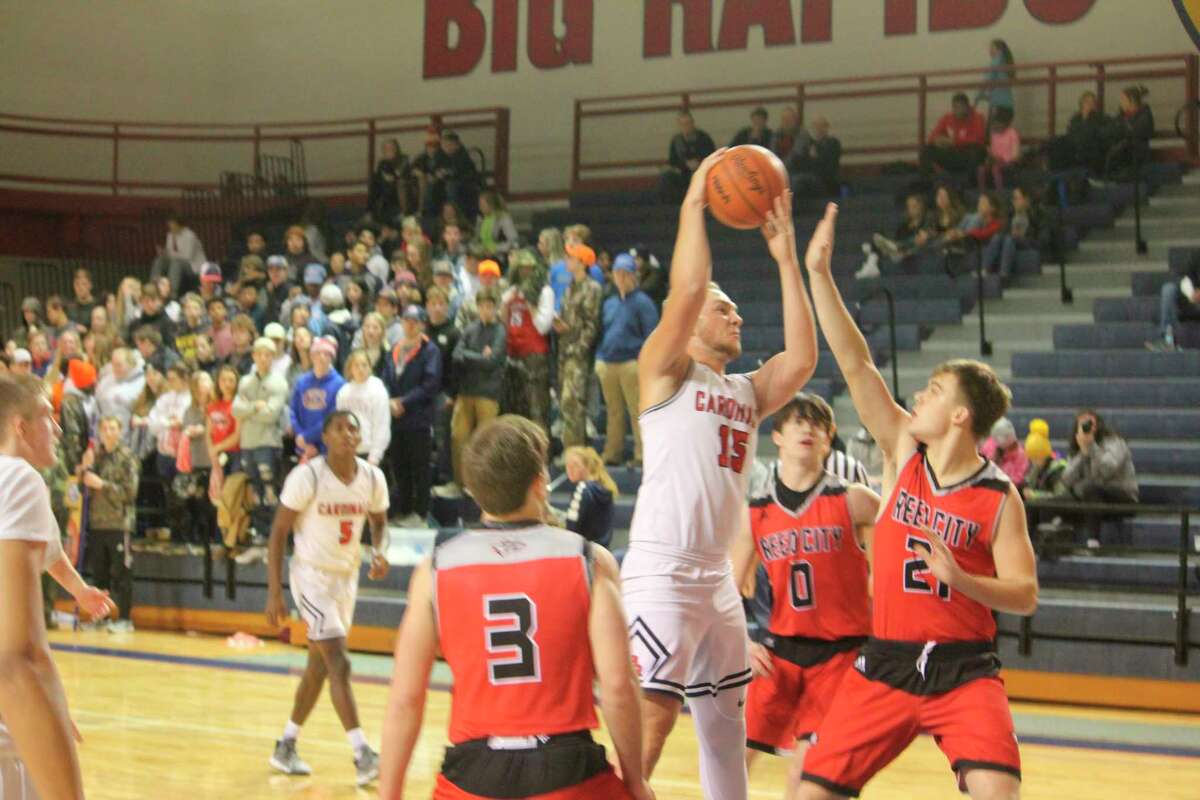 Reed City's Chaz Davis tries to block Big Rapids' LJ Graves from the basket in Friday action. (Herald Review photo/John Raffel)