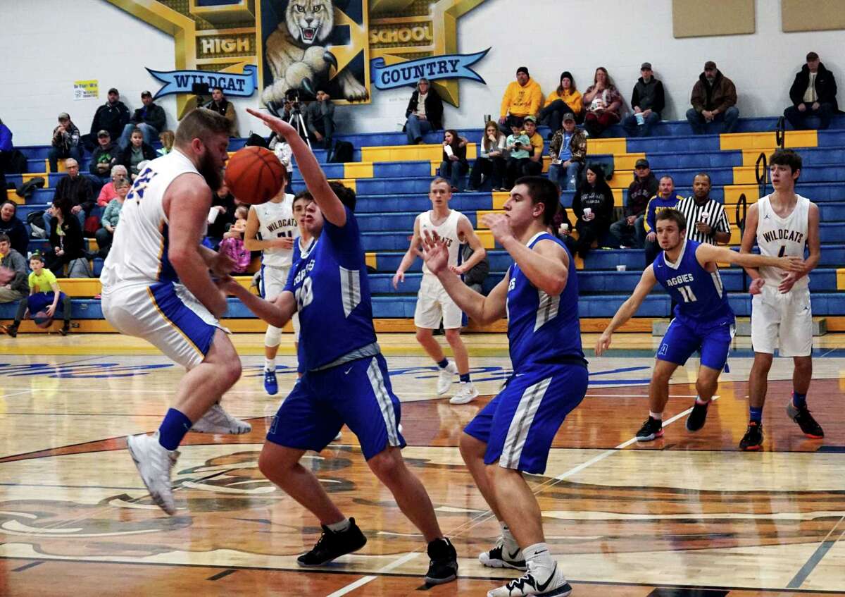 Evart senior Justin Buckner battles for possession of the ball with Beal City's Ivan Paul during Evart's 46-37 win on Monday night. (Herald Review photo/Joe Judd)