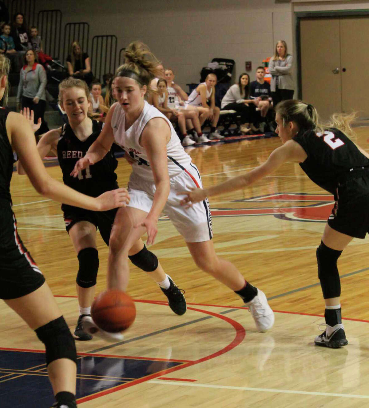 Reed City's Paige Lofquist (left) goes after the ball against Big Rapids on Friday in CSAA action.