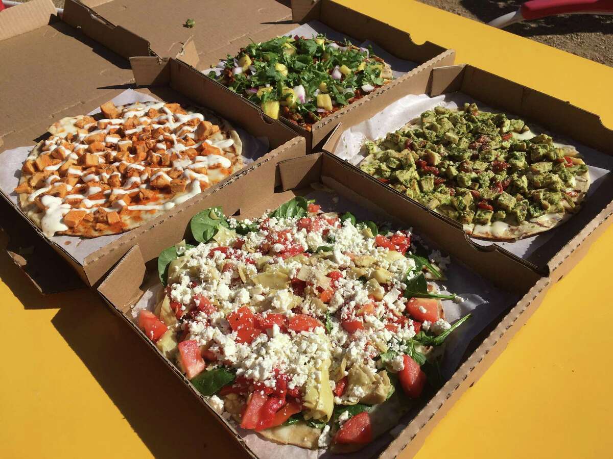 A selection of pizzas from Bob & Timmy's on Wheels includes, clockwise from top left, a buffalo chicken, al pastor, pesto and veggie medley.