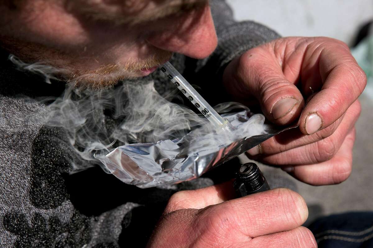 Garrett, who is homeless, smokes fentanyl on Turk Street in San Francisco last year. A San Francisco Superior Court judge denied motions by City Attorney Dennis Herrera to ban four alleged drug dealers from a roughly 50-square-block area of the Tenderloin.