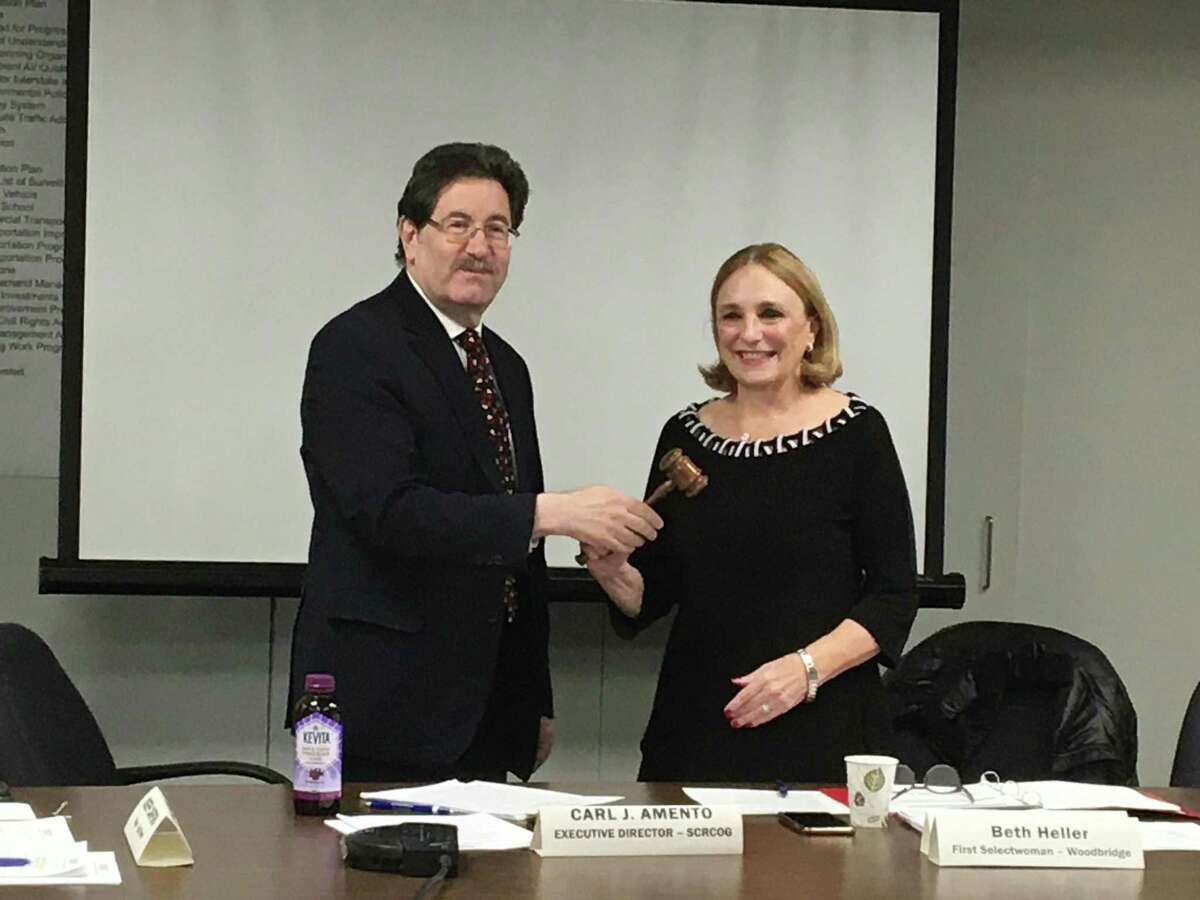 Woodbridge First Selectwoman Beth Heller accepts the South Central Regional Council of Governments gavel Wednesday from COG Executive Director Carl Amento on Wednesday, Jan. 22, 2020. The COG unanimously elected Heller to be chairwoman of the 15-municipality regional government agency for the coming year.
