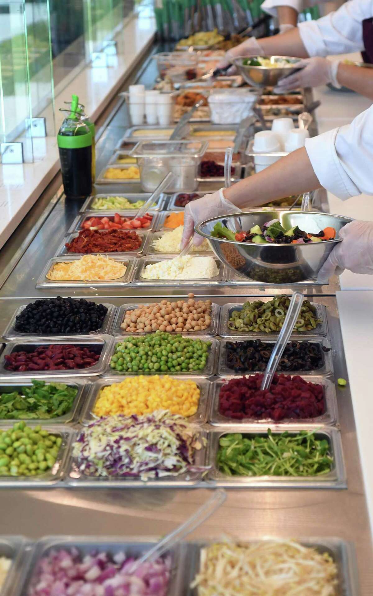 Salads being prepared at Salata in Beaumont. The Beaumont restaurant allows customers to design their own salad with dozens of ingredients to choose from. Photo taken Tuesday, April 24, 2018 Guiseppe Barranco/The Enterprise