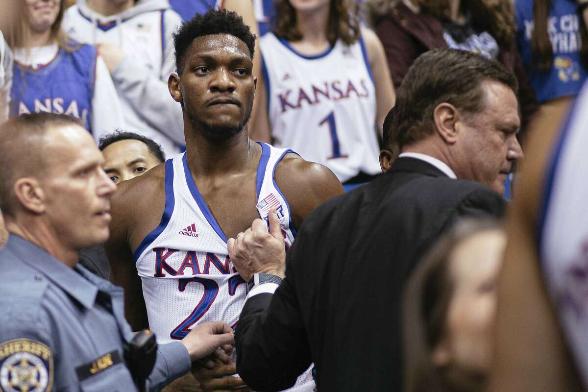 Kansas forward Silvio De Sousa (22) and coach Bill Self stand on court side following a brawl in the second half of an NCAA college basketball game against Kansas State, Jan. 21, 2020 in Lawrence, Kan. (Emma Pravecek/University Daily Kansan via AP)