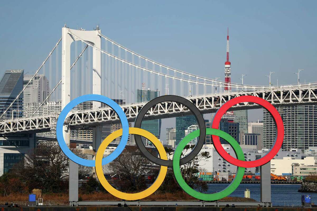 TOKYO, JAPAN - JANUARY 20: The Olympic rings are seen in front of Tokyo's iconic Rainbow Bridge and Tokyo Tower on January 20, 2020 in Tokyo, Japan.