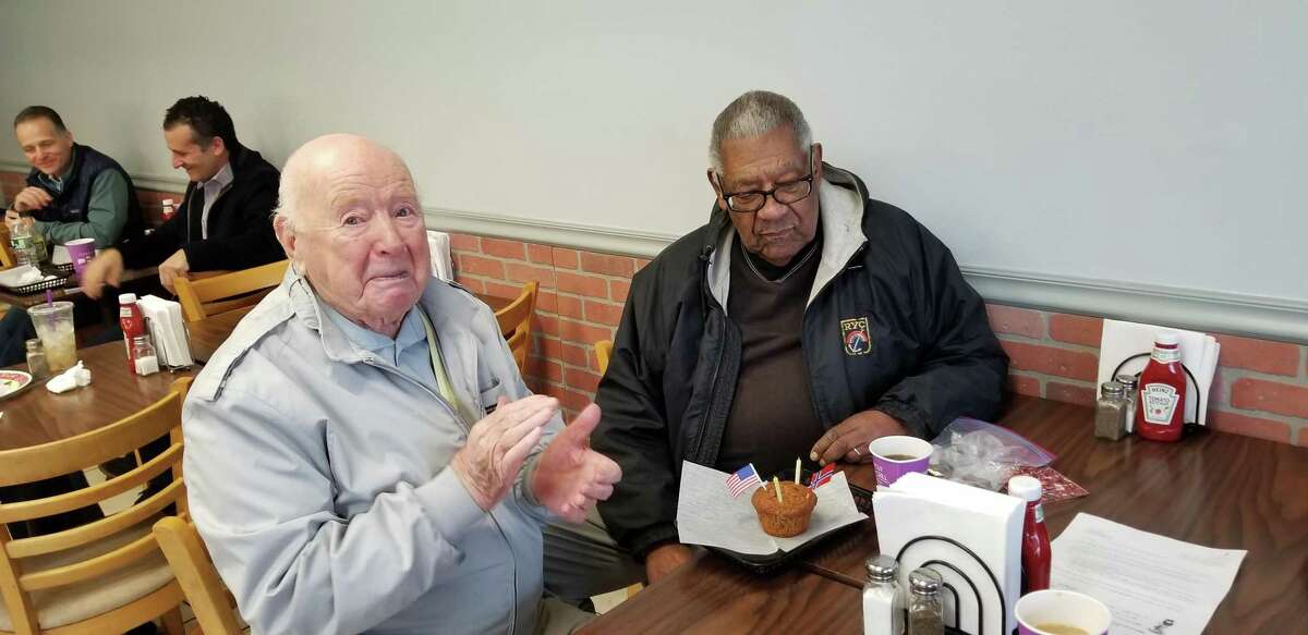 Trygve Hanson, left, and Doug Jones contemplate the cupcake commemorating their 98th and 95th birthdays, respectively.