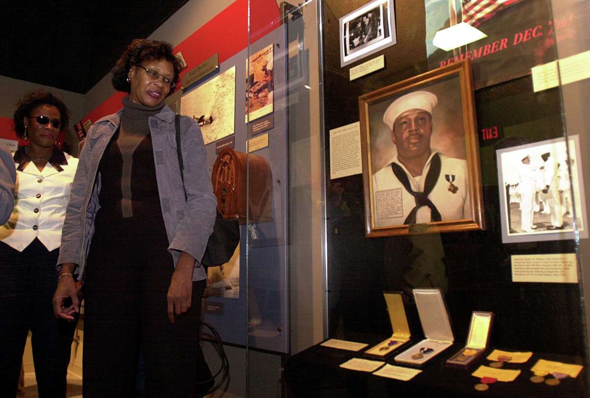 In 2001, Henrietta Miller-Bledsoe, right, joins sisters Vickie Gail Miller and Florietta Miller, not shown, at the unveiling ceremony for their uncle and Pearl Harbor hero Doris “Dorie” Miller at the National Museum of the Pacific War in Fredericksburg. The U.S. Navy has named an aircraft carrier after Miller — and rightly so.