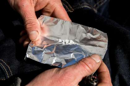 A homeless man named Garrett (no last name given) prepares to smoke Fentanyl while sitting along Turk Street in San Francisco, Calif. Wednesday, Jan. 22, 2020. Alarmed by a new report that fentanyl deaths more than doubled in San Francisco last year -- from 90 in 2018 to 234 in 2019 -- Supervisor Matt Haney is calling for more action to battle the city's spiraling opioid epidemic.