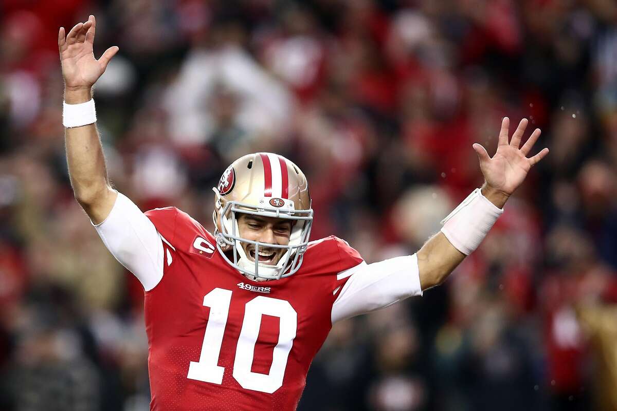 SANTA CLARA, CALIFORNIA - JANUARY 19: Jimmy Garoppolo #10 of the San Francisco 49ers celebrates a touchdown by Raheem Mostert #31 in the second quarter against the Green Bay Packers during the NFC Championship game at Levi's Stadium on January 19, 2020 in Santa Clara, California. (Photo by Ezra Shaw/Getty Images)