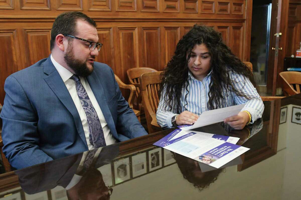 David Galin, left, chief of staff for Albany Mayor Kathy Sheehan, and Jasmine Higgins, City of Albany constituent services assistant, go over an informational flyer for the census at City Hall on Wednesday, Jan. 15, 2020, in Albany, N.Y. (Paul Buckowski/Times Union)