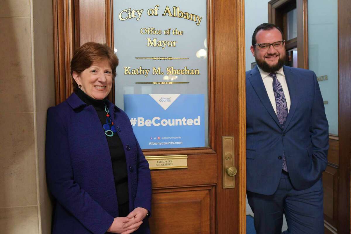 Mayor Kathy Sheehan, left, and her chief of staff, David Galin, pose next to a sign promoting the census on the door to the Mayor's office at City Hall on Wednesday, Jan. 15, 2020, in Albany, N.Y. (Paul Buckowski/Times Union)